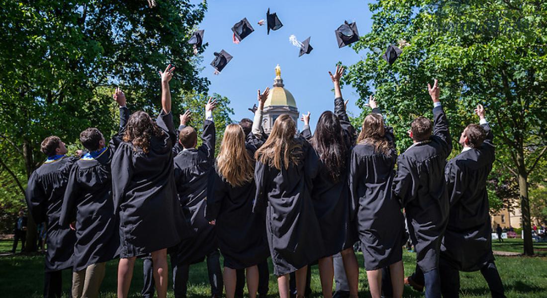 Graduates throwing caps at Notre Dame