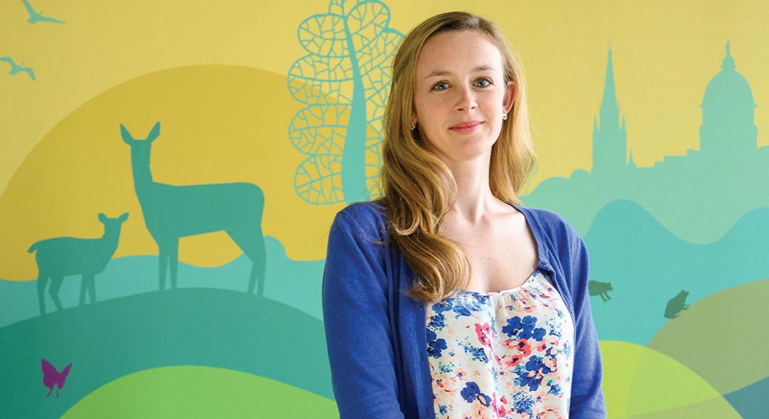 Laura Miller Graff standing in front of colorful mural