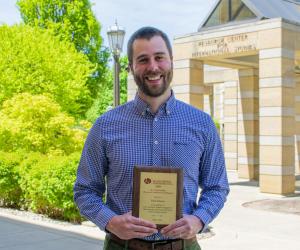 Paul Friesen accepts Award for Outstanding Doctoral Student Contributions