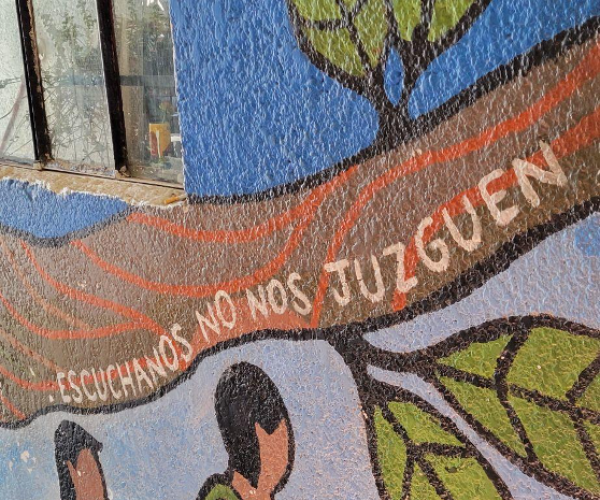 “Listen to us, don't judge us,” says one of the murals painted by migrants in Albergue Tochán.